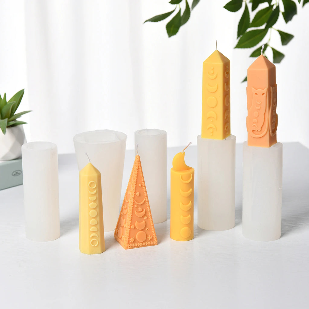 Five moon-phase pillar example candles displayed with their white silicone molds