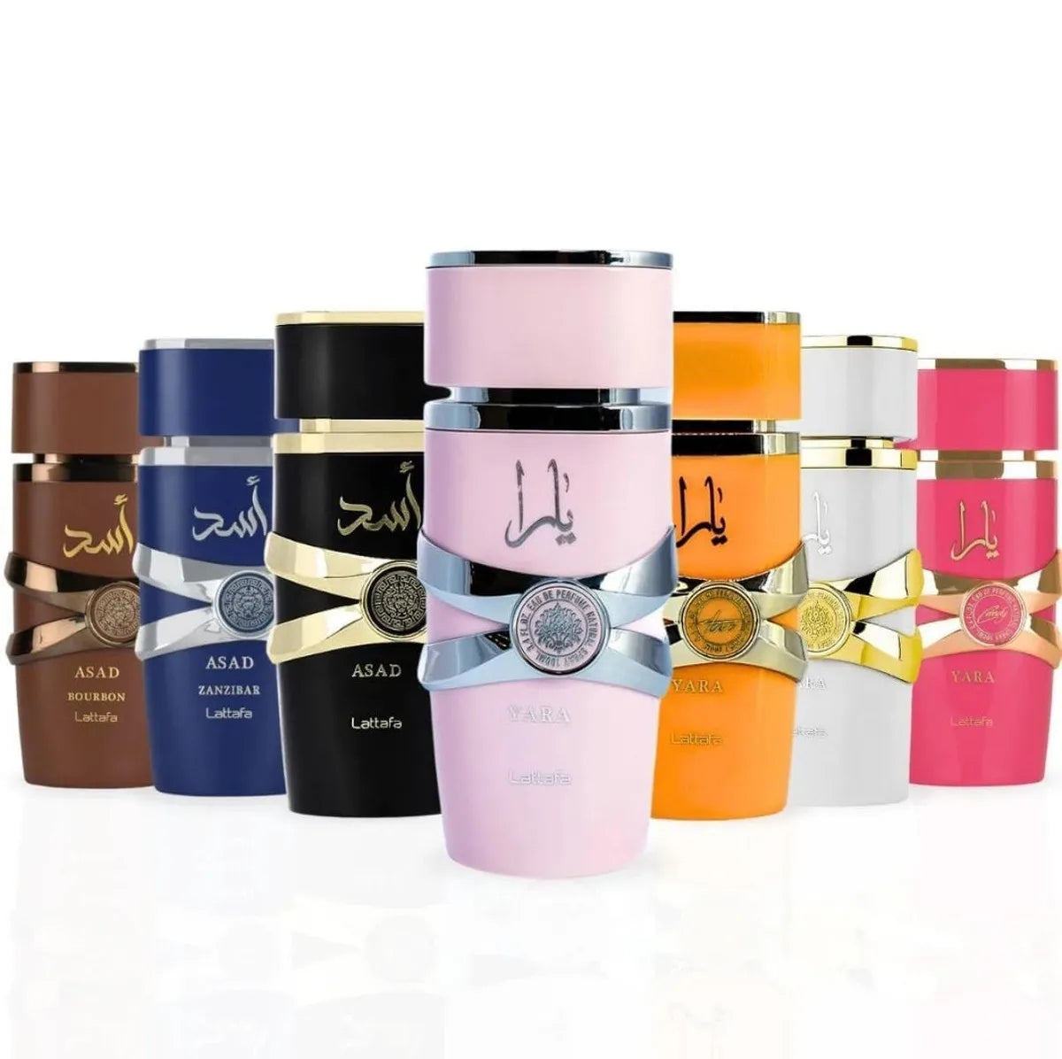 A group of Lattafa Perfume cylindrical perfume bottles arranged in a row on a white reflective surface. The center bottle is light pink with a silver band and gold seal, flanked by bottles in brown, blue, black, orange, white, and pink, each with Arabic script on the front.