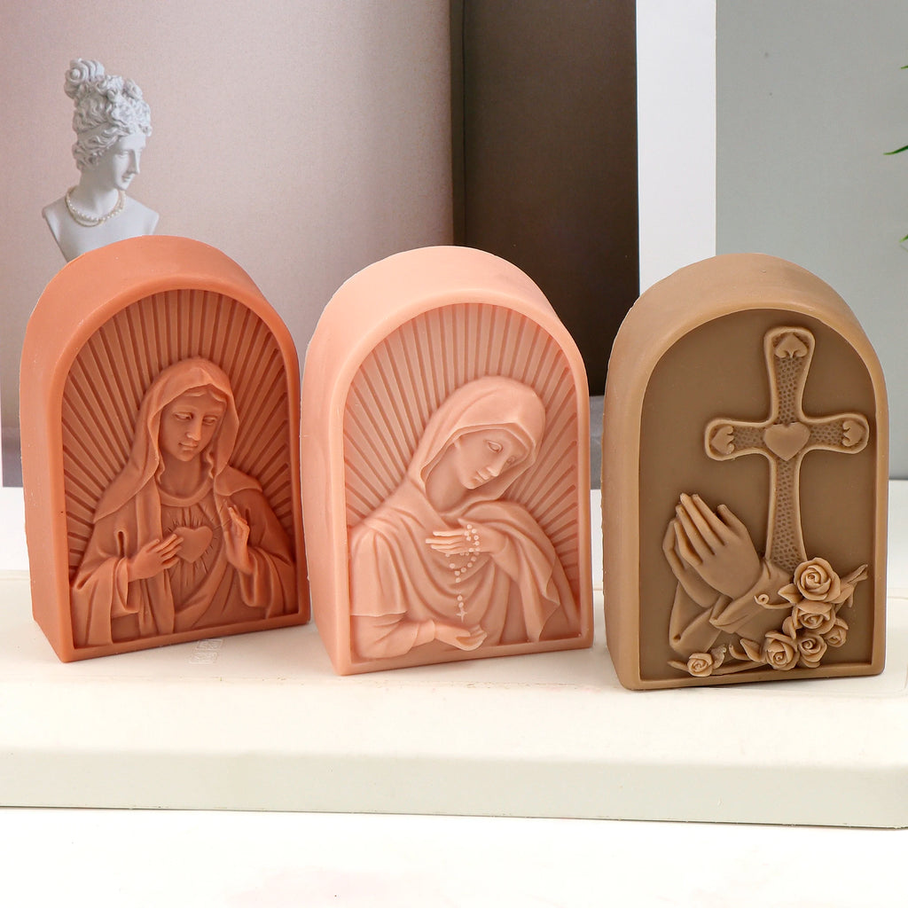 Three arched religious relief examples with Sacred Heart Virgin Mary, bowed Virgin and cross with roses