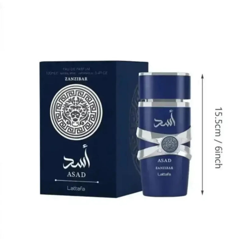 A bottle of ASAD Zanzibar Lattafa perfume next to its dark blue packaging box, with a vertical dimension marker indicating a height of 15.5cm (6 inches) on a plain white background.