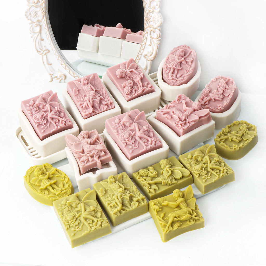 Pink and yellow-green fairy relief soap casting examples arranged with matching white silicone molds