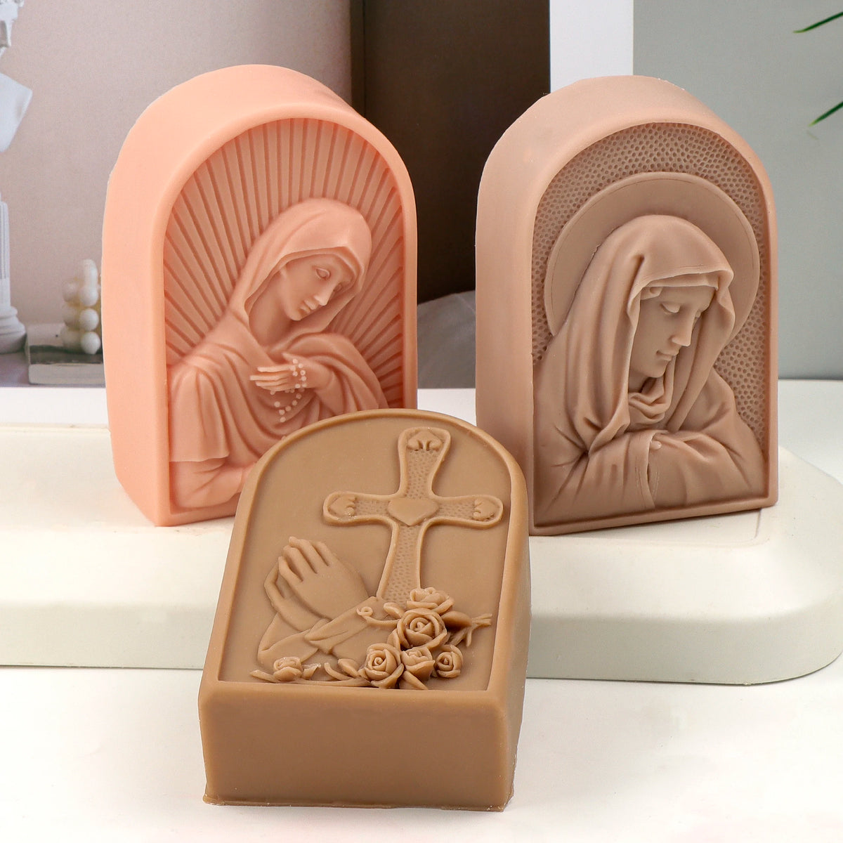 Three arched relief casting examples with bowed Virgin Mary, praying Virgin and cross with praying hands