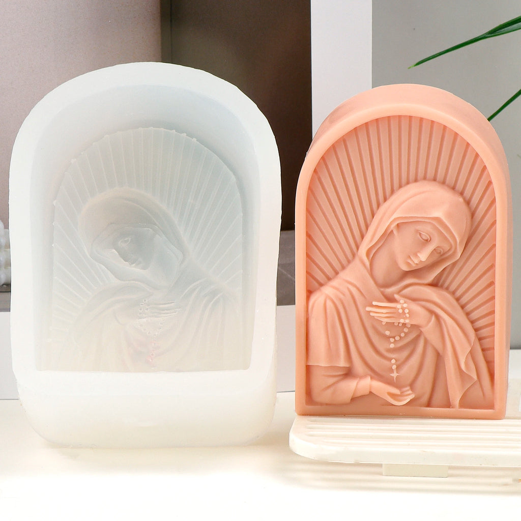 Peach bowed Virgin Mary relief casting beside its white arched silicone mold