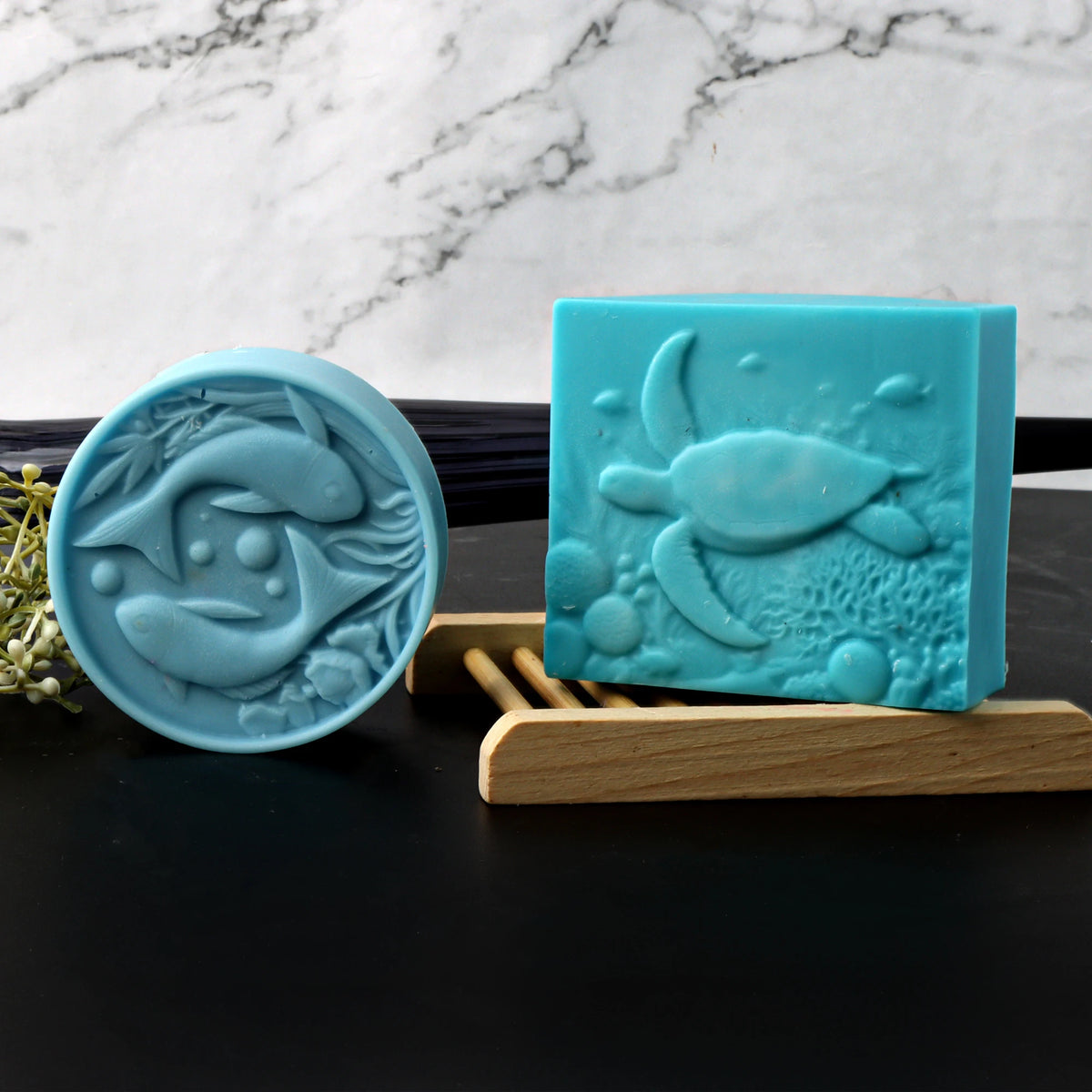 Round blue paired-dolphin and square turquoise sea-turtle soap casting examples