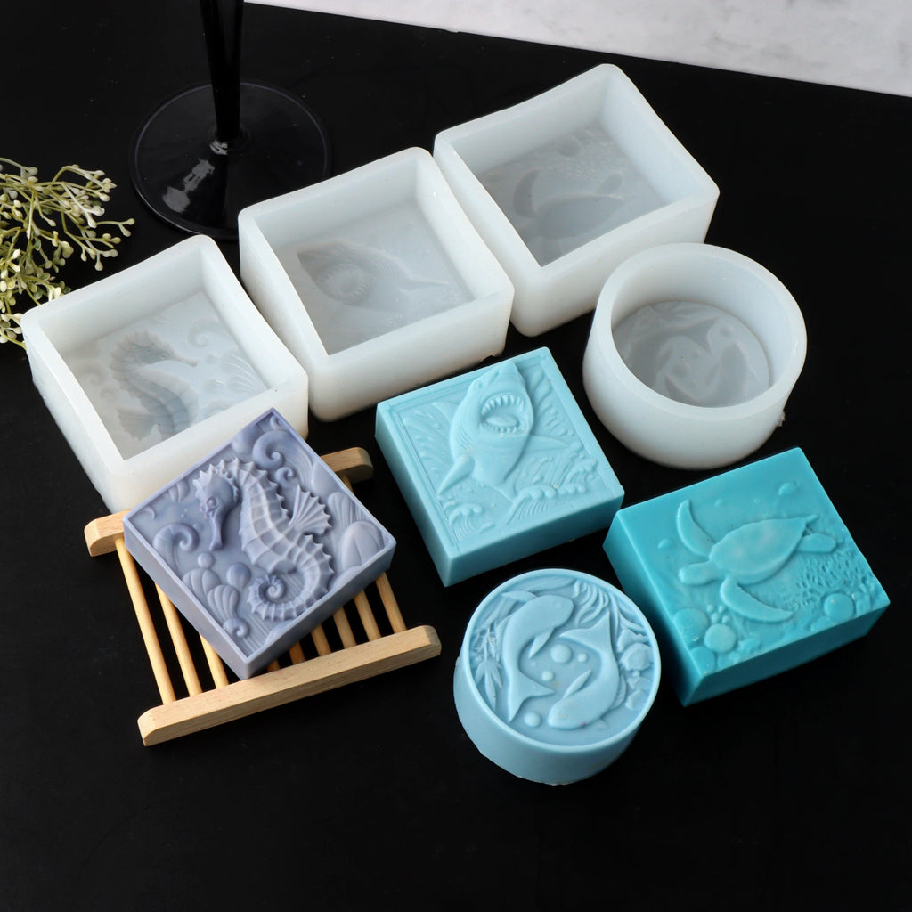 Four sea-animal soap casting examples with their white square and round silicone molds