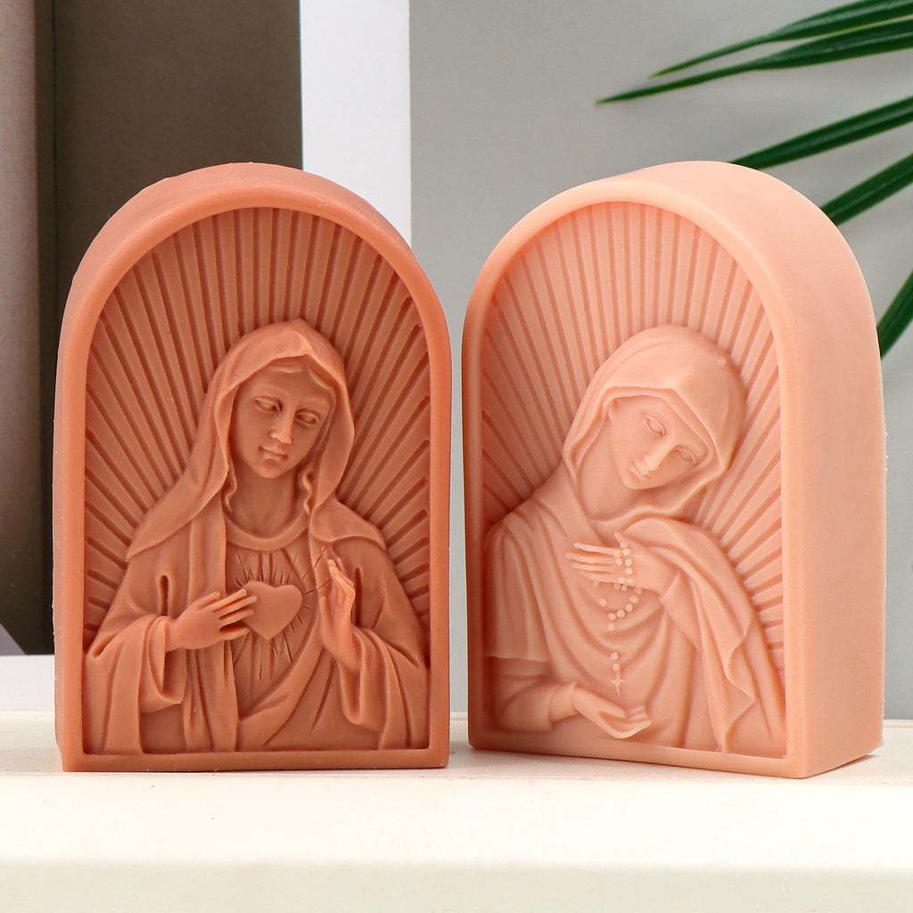 Two peach arched Virgin Mary relief casting examples with radiating backgrounds