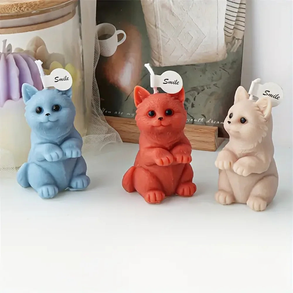 Blue, red and ivory upright kitten example candles with raised front paws and Smile tags