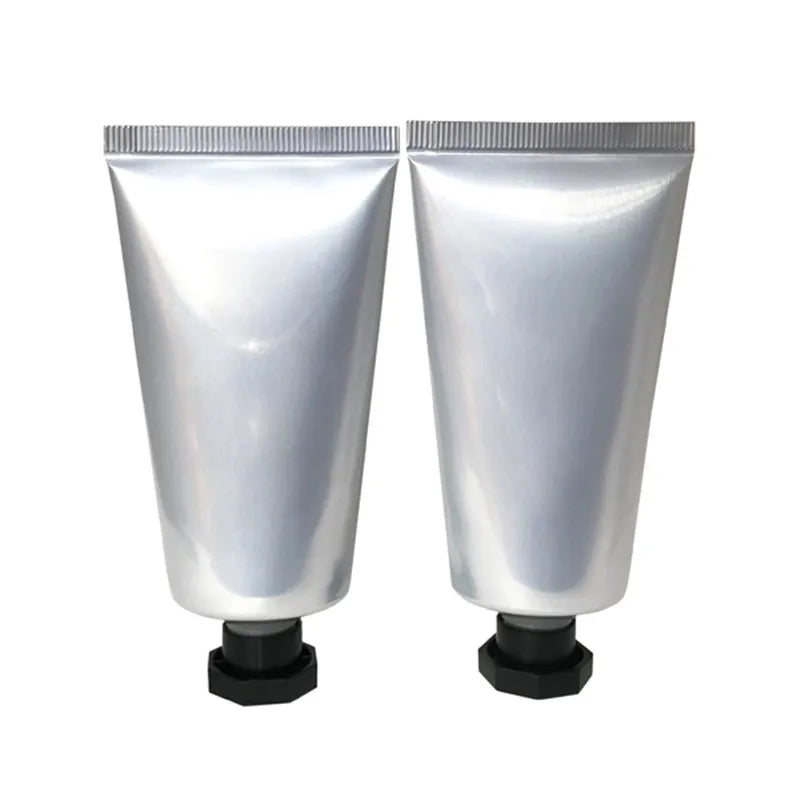 Two silver-finish squeeze tubes with black faceted screw caps