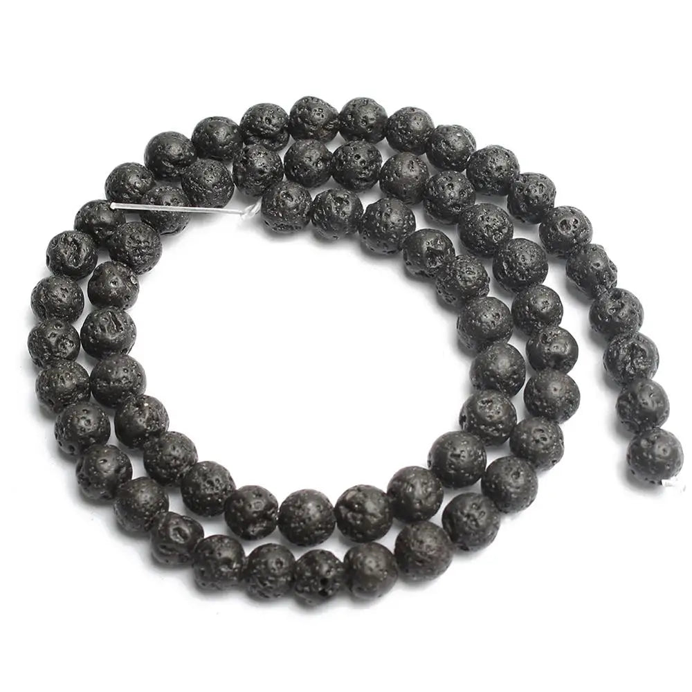 A coiled strand of textured black lava stone beads on a plain white background.