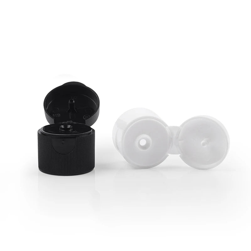 Black, white and translucent flip-top bottle closures with lids open