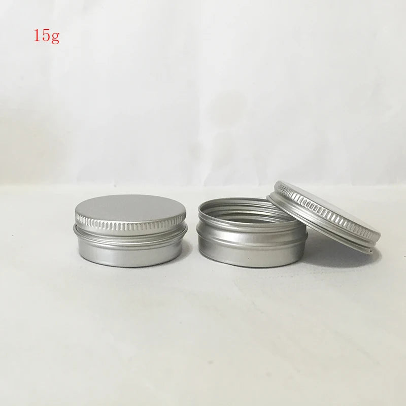 Small round silver aluminum tins with one screw lid closed and one open