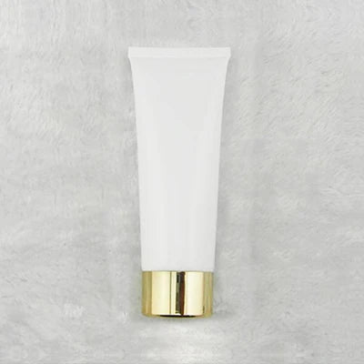 White squeeze tube with gold-tone cylindrical cap, style 11