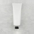 White squeeze tube with small black cap, style 1