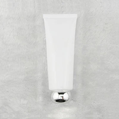 White squeeze tube with rounded silver-tone cap, style 13