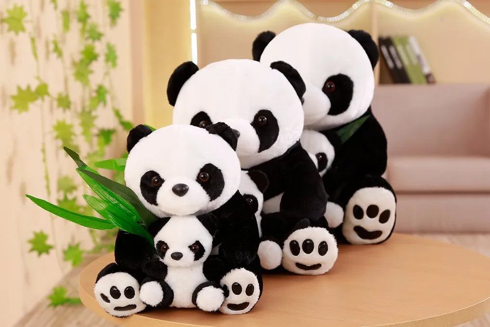 Set of panda plush toys on a wooden surface with a decorative background