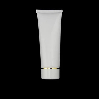 White squeeze tube with white cap and gold-tone band, style 9