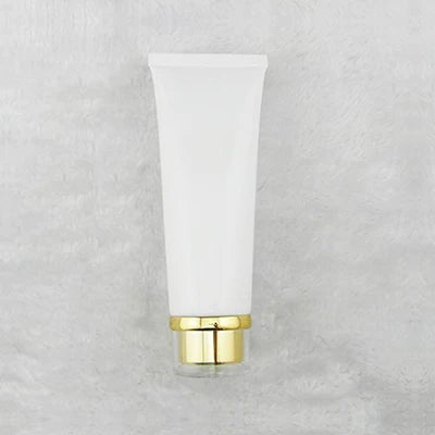 White squeeze tube with stepped gold-tone cap, style 3
