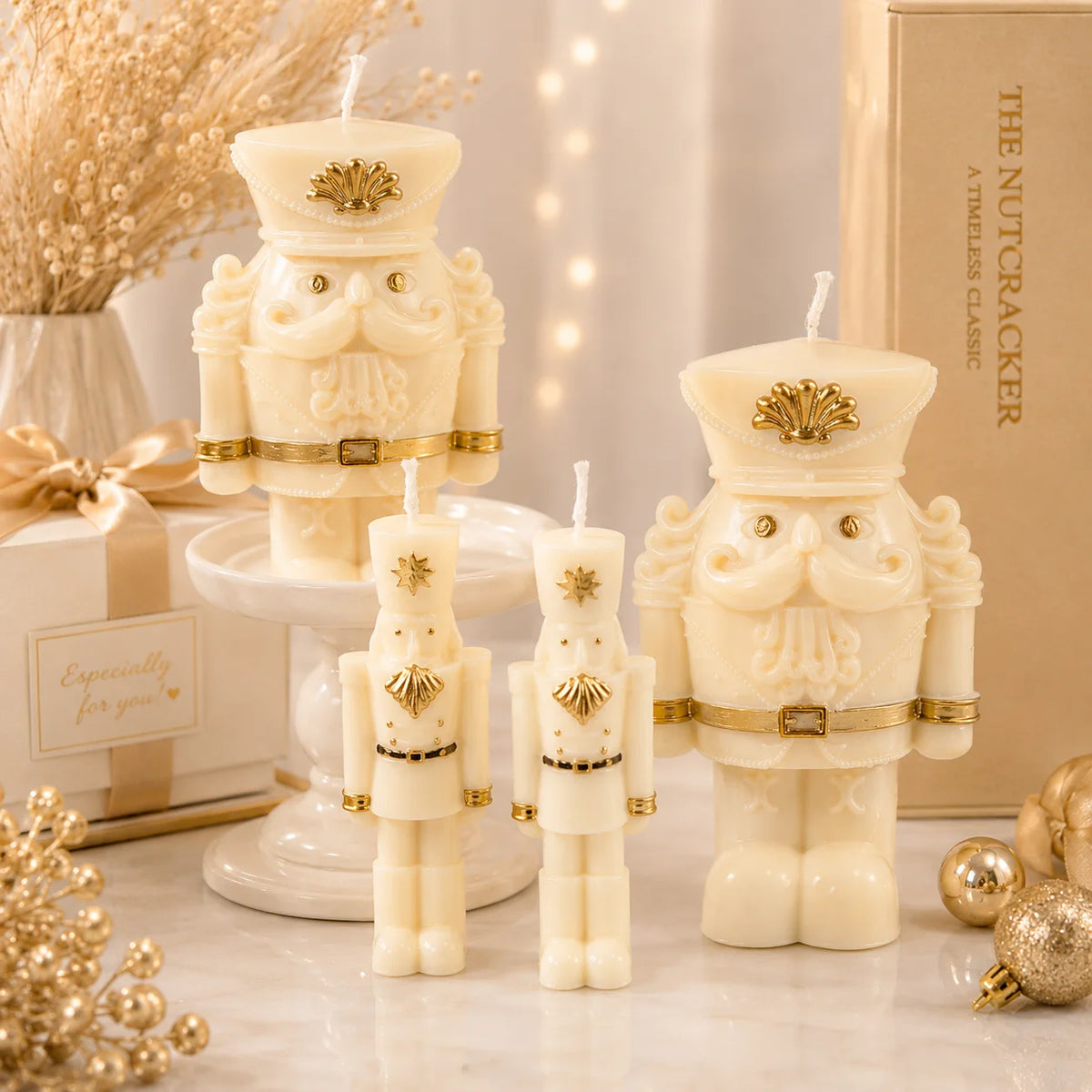 Four ivory nutcracker soldier example candles in slender and wide-bodied styles with gold-colored trim