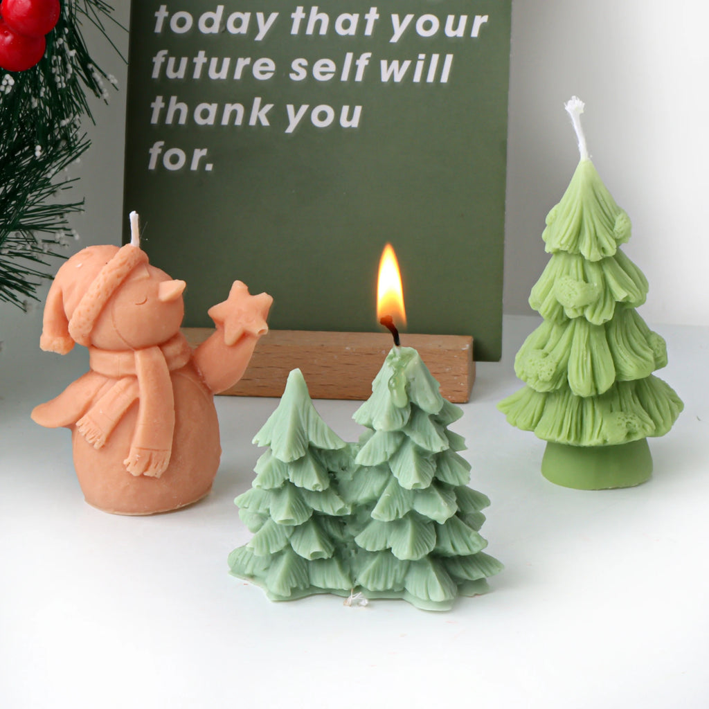 Orange snowman, light green single tree and mint three-tree cluster examples, with one small tree lit
