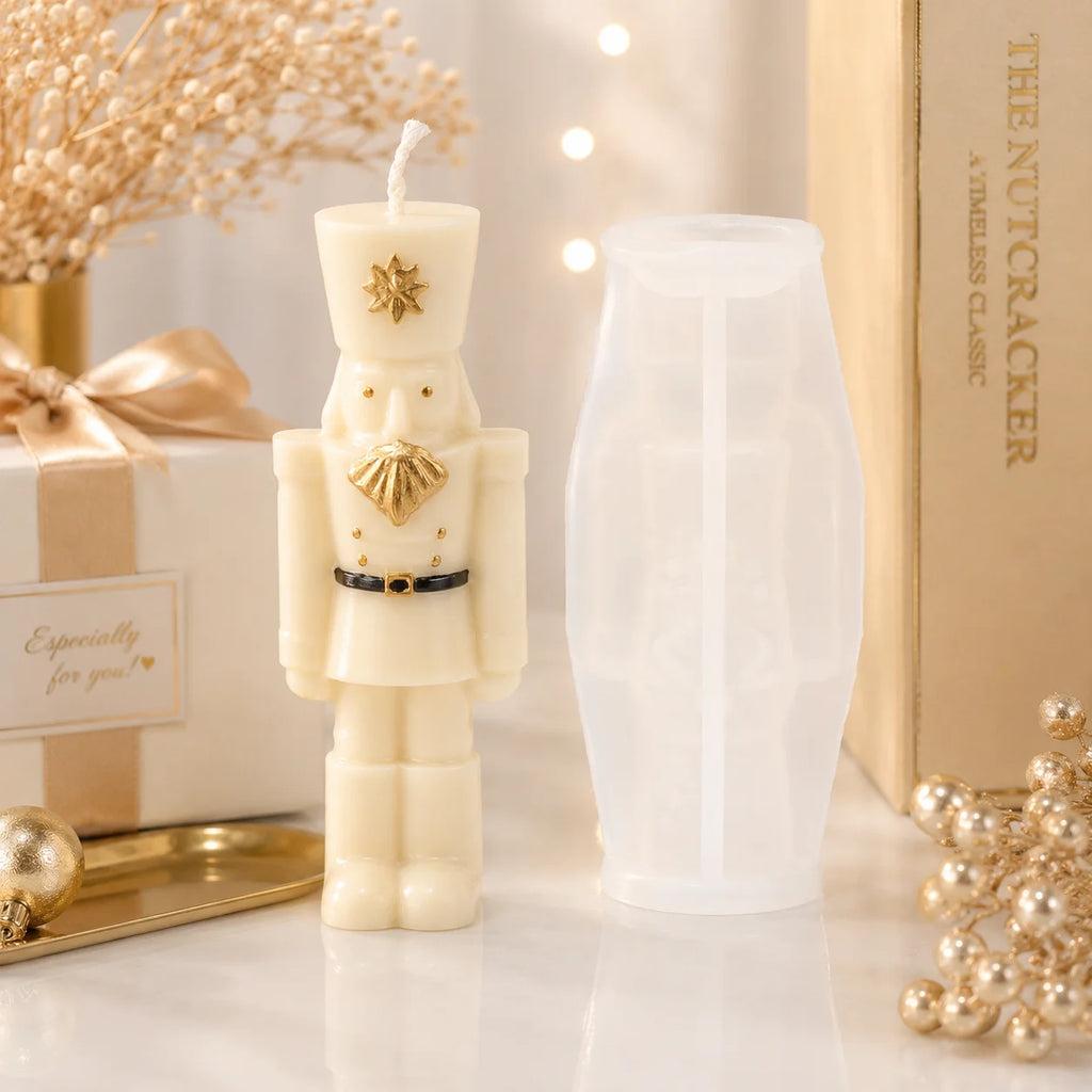 Slender ivory nutcracker soldier example candle beside its white silicone mold