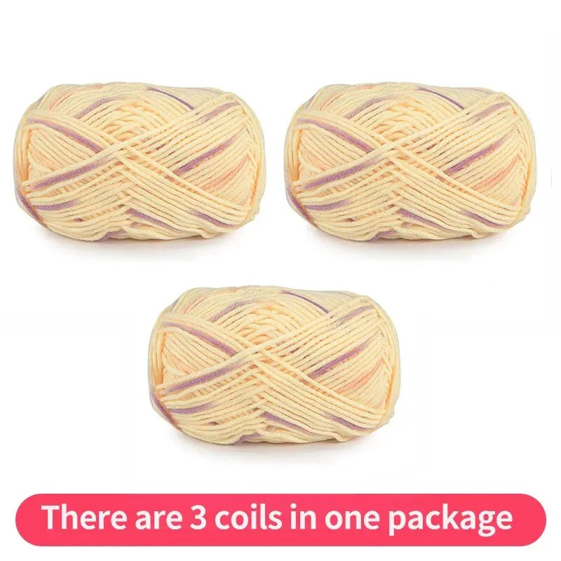 Three pale yellow yarn skeins with lavender and peach accents, shown as one package.