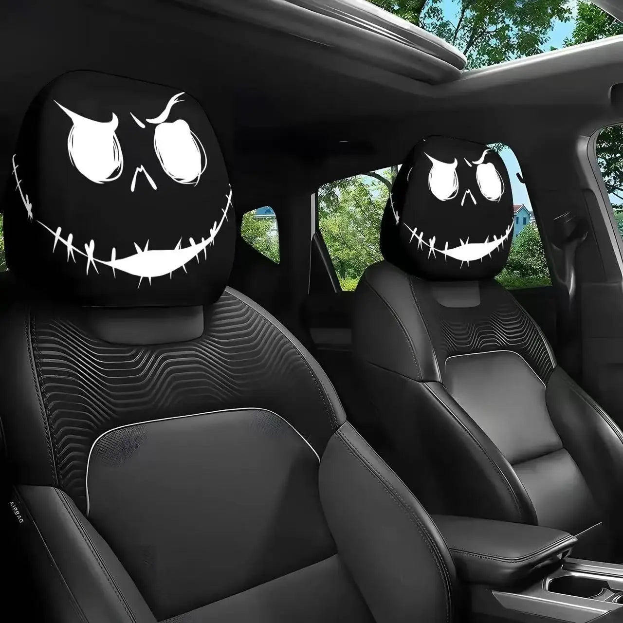 Car interior with black headrest covers featuring ghost face designs.