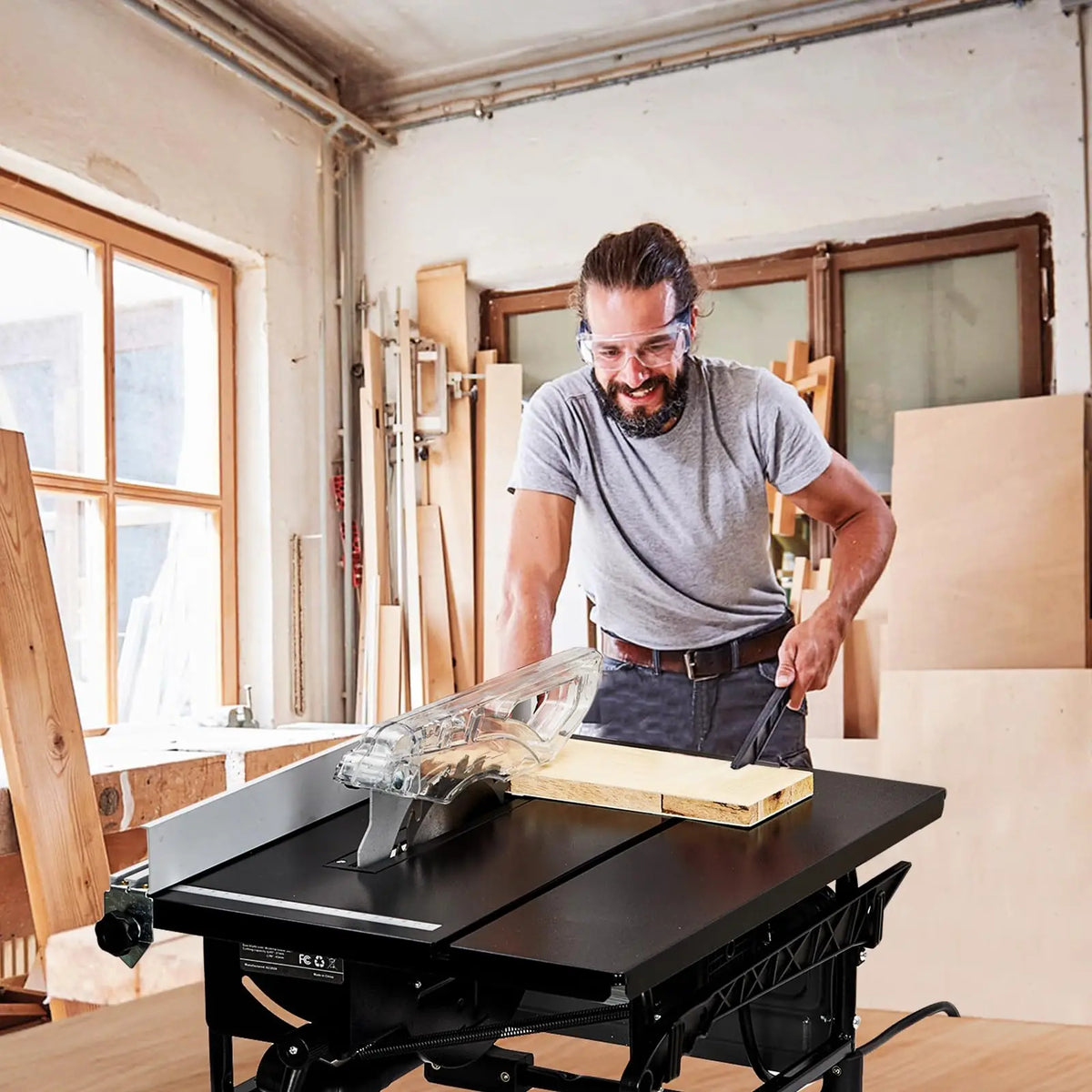 Man using a table saw in a workshop