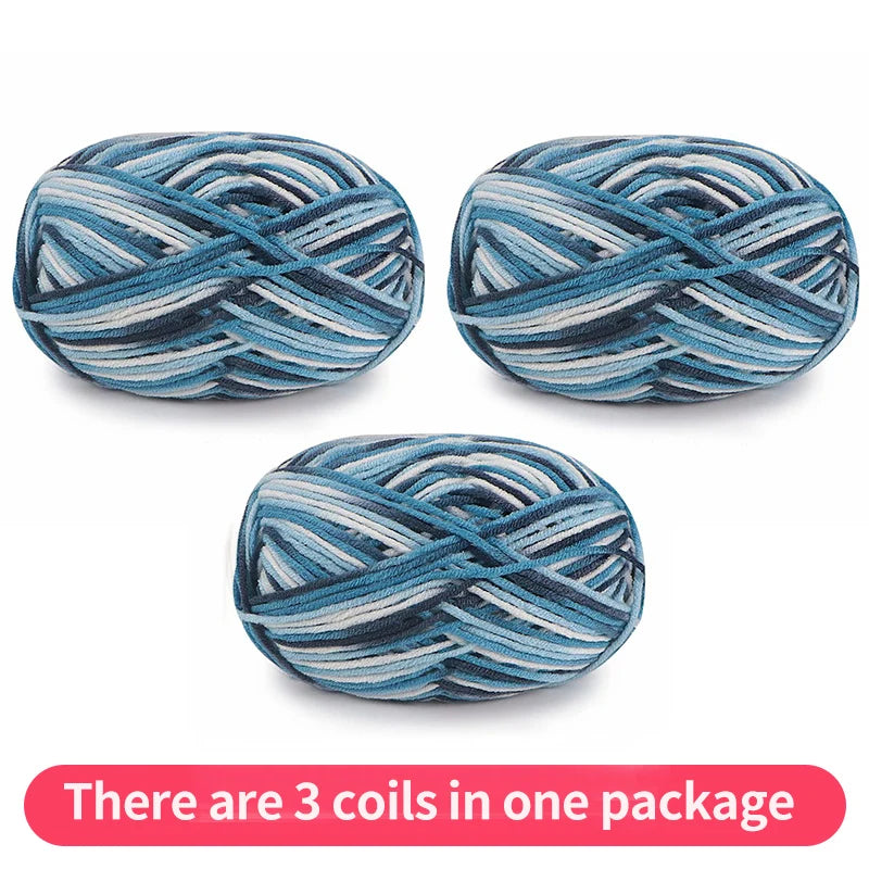 Three variegated yarn skeins in teal, pale blue, gray and white, shown as one package.