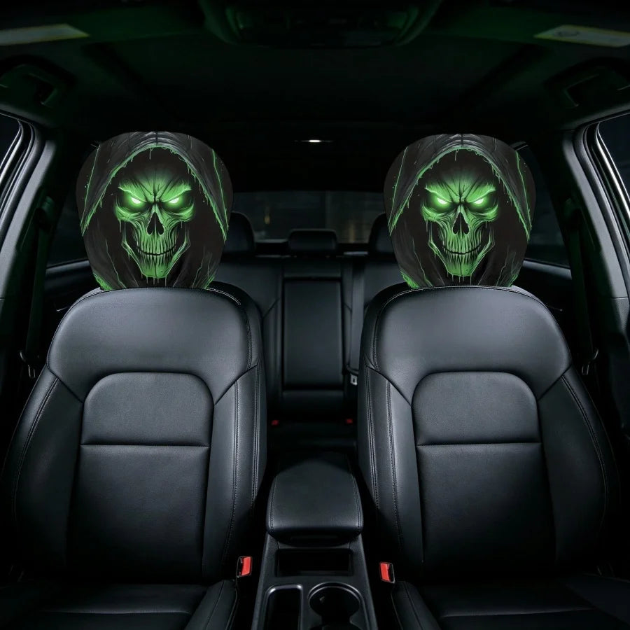 Two black car headrest covers installed on the front seats of a vehicle, featuring a glowing green skull and hooded figure design on the headrests.