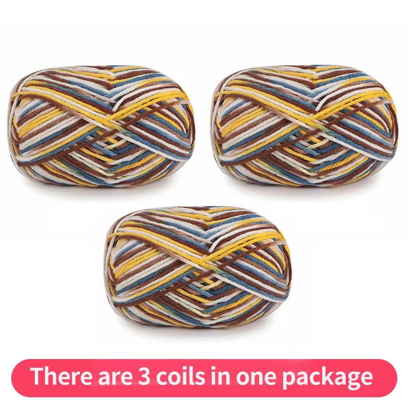 Three variegated yarn skeins in brown, blue, yellow and cream, shown as one package.