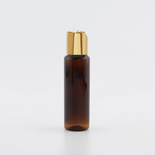 Brown PET bottle with gold-tone disc-top cap and white insert