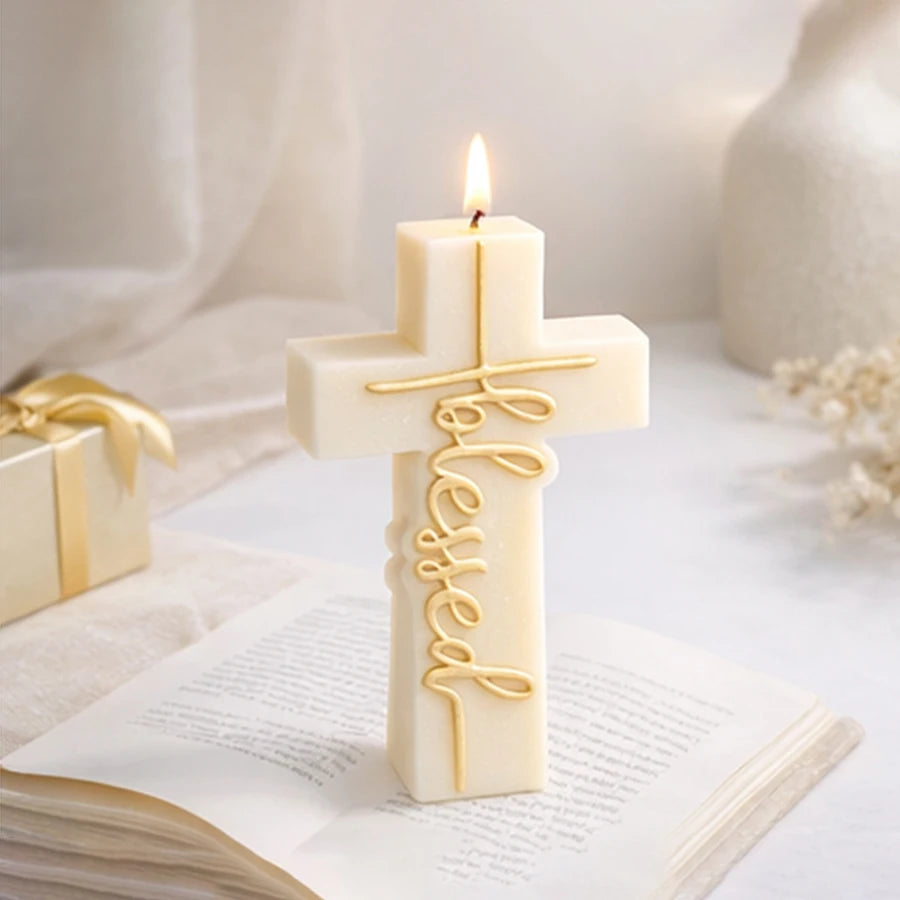 Lit ivory Blessed cross example candle standing on an open book