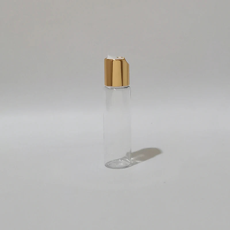 Clear PET bottle with gold-tone disc-top cap and white insert, clear-2