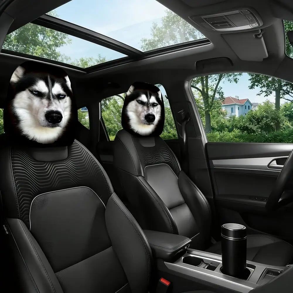 Two black car seat covers with printed husky dog faces installed on the front seats inside a modern car cabin.