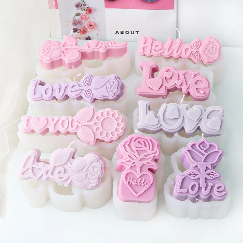 Nine pink and lavender romantic lettering example candles arranged on matching silicone molds