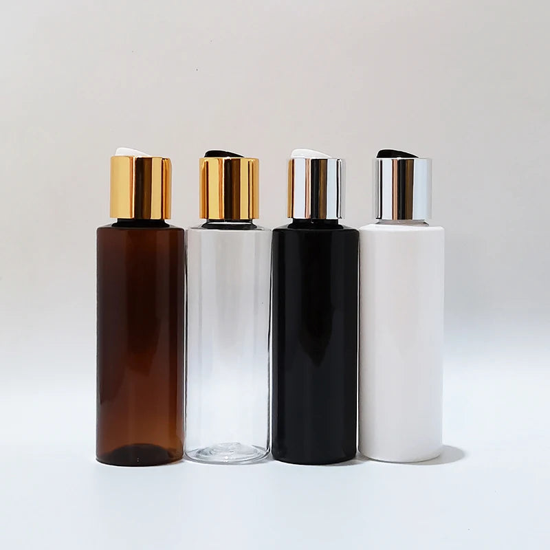 Brown, clear, black and white empty bottles with metallic-tone disc caps