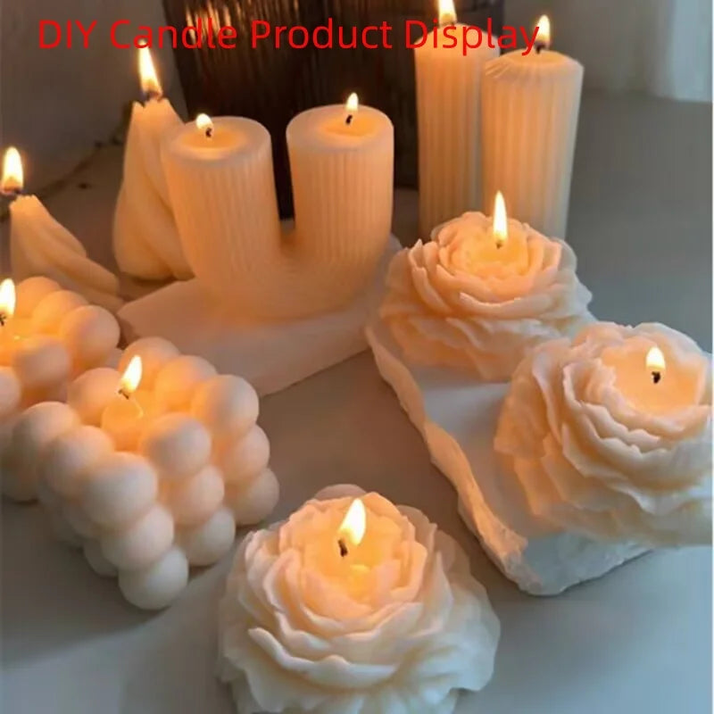 A collection of white novelty candles, including rose-shaped, bubble-cluster-shaped, and U-shaped candles, some lit with visible flames, arranged on a light surface.