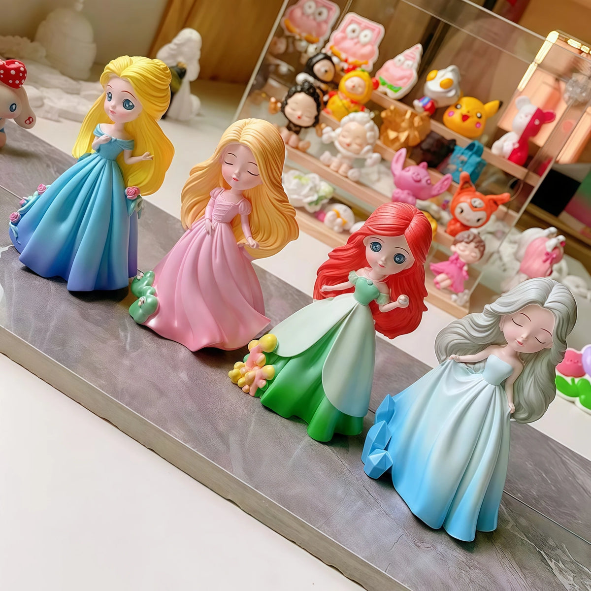 Four painted princess doll casting examples with blue, pink and green dresses and different hair colors