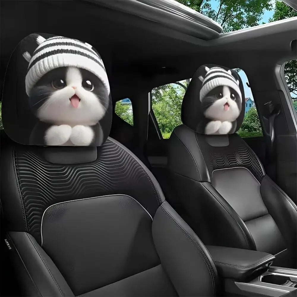 Car interior with cartoon cat headrest covers on black leather seats.