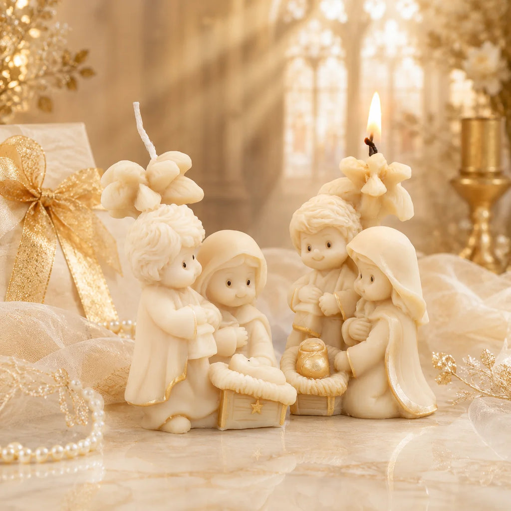 Two ivory Nativity candle examples with flower backdrop, lantern, baby Jesus and gold-colored accents