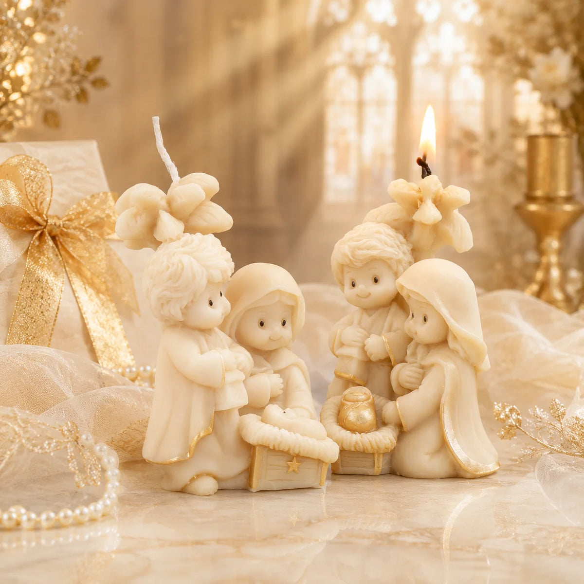 Two ivory Nativity candle examples with flower backdrop, lantern, baby Jesus and gold-colored accents