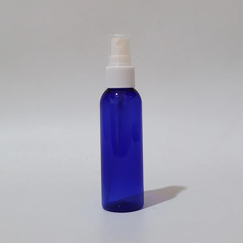 Blue round spray bottle with white sprayer and clear protective cap