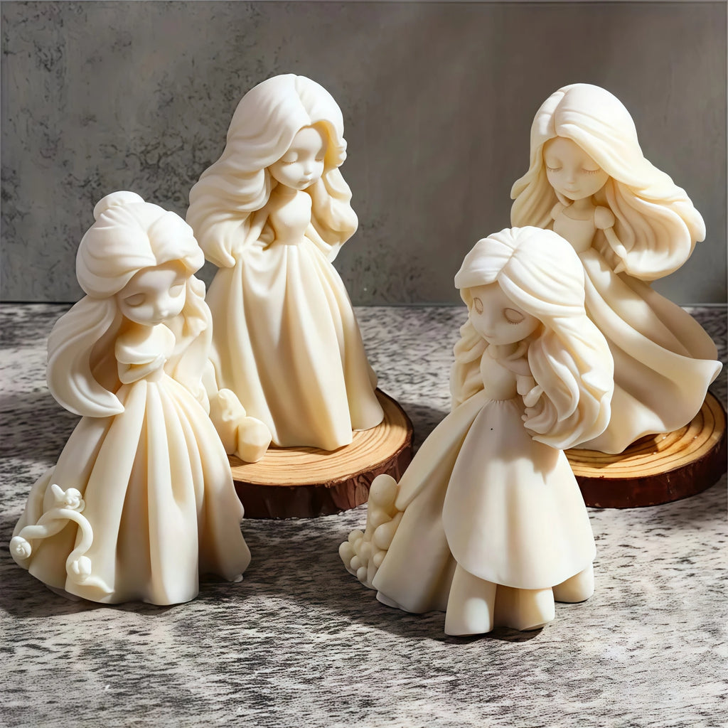 Four ivory princess doll casting examples arranged on wood slices with different hair and gown details