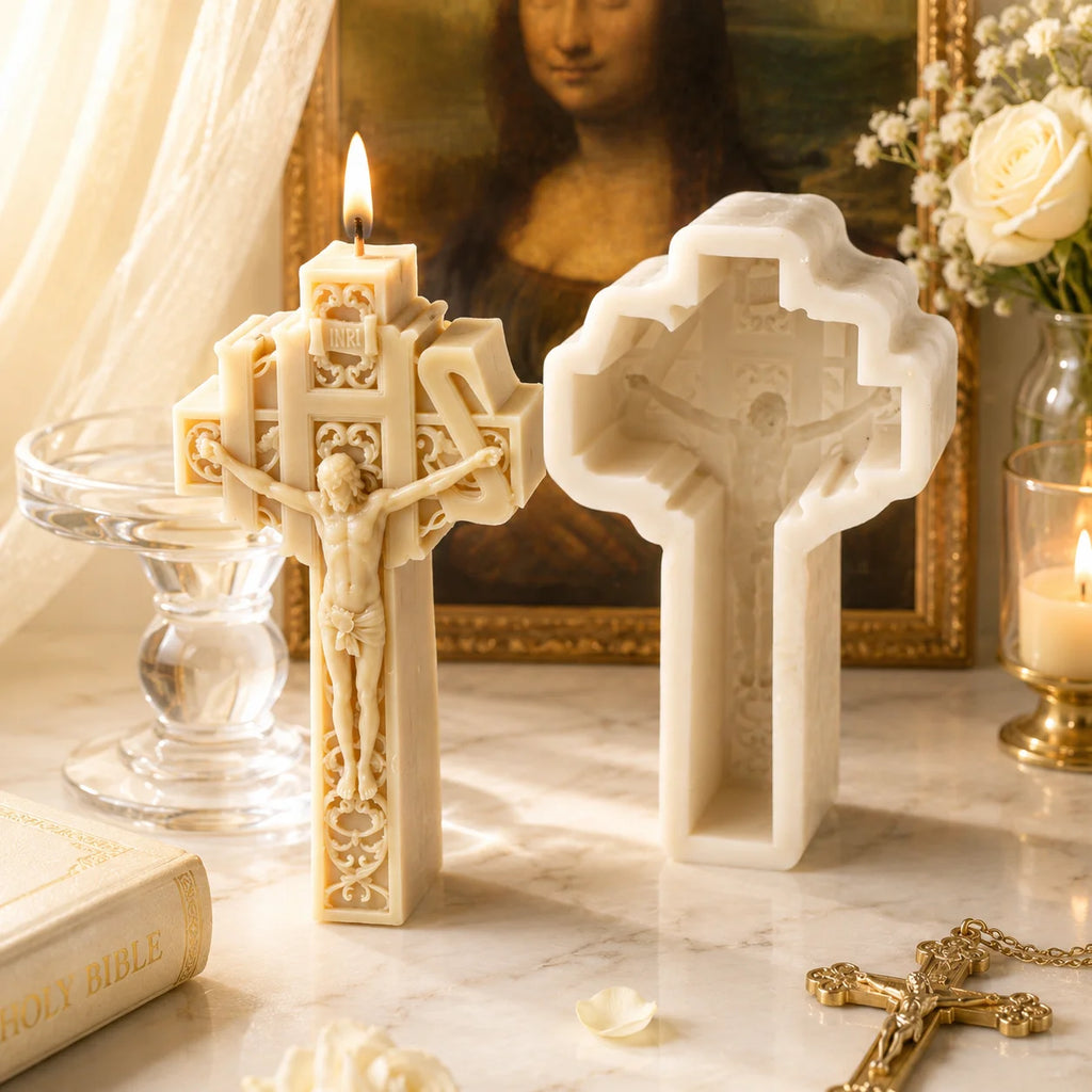 Lit ivory scrollwork crucifix example candle beside its white silicone mold