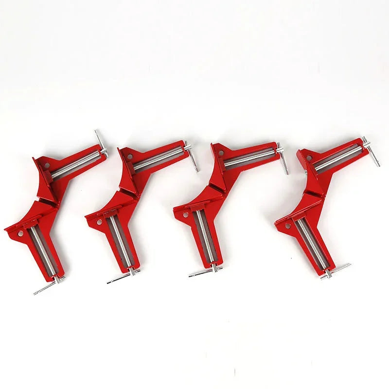 Four picture frame corner clamps arranged in a row on a white background