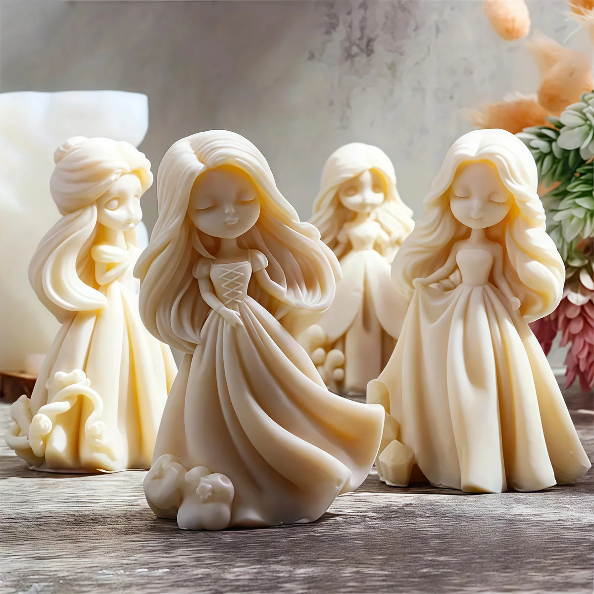 Four ivory princess doll casting examples with long flowing hair, full dresses and closed-eye faces