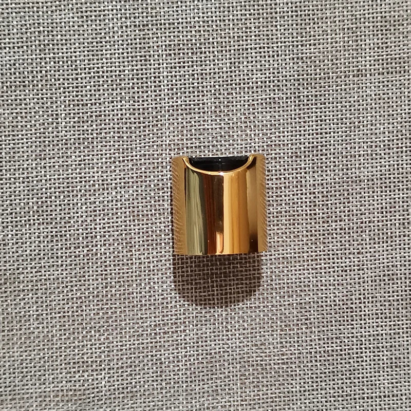 Gold-tone disc-top bottle closure with black top insert