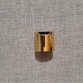 Gold-tone disc-top bottle closure with black top insert
