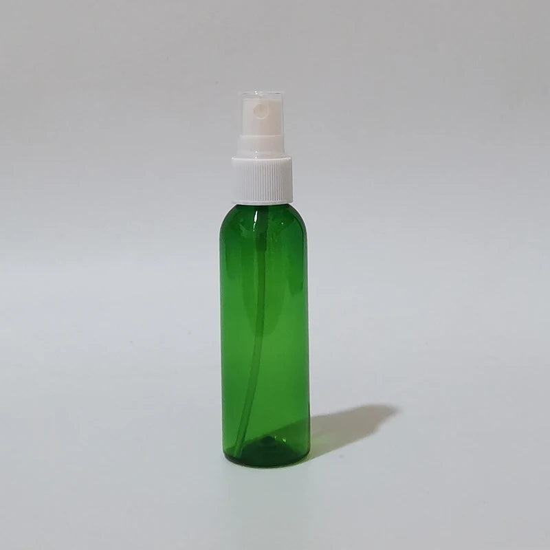 Green round spray bottle with white sprayer and clear protective cap