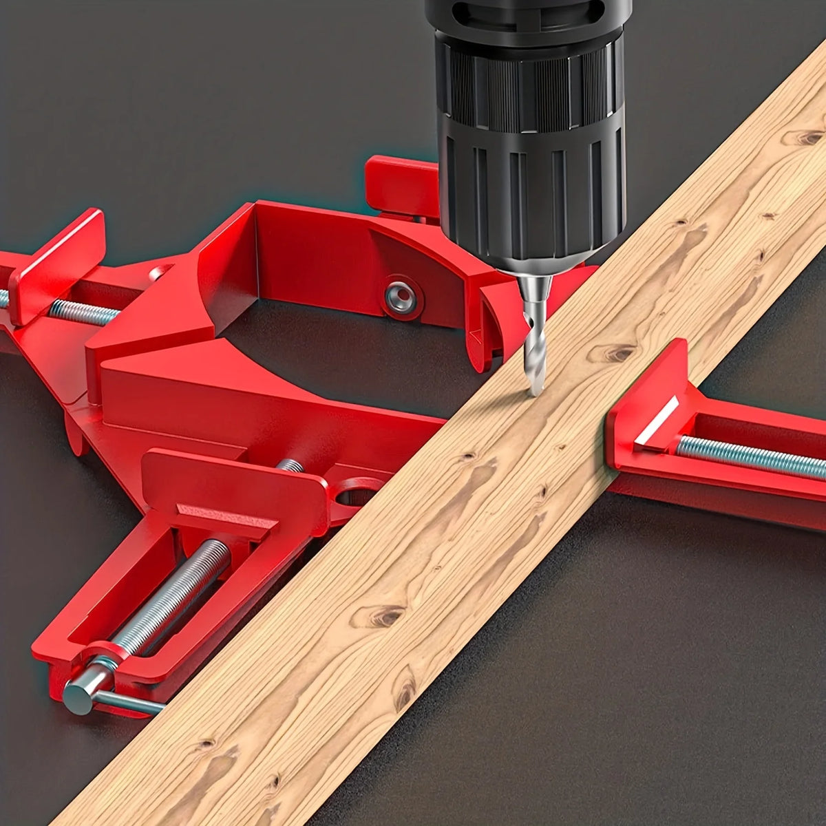 Red clamp holding a piece of wood as a drill bit approaches, on a dark background